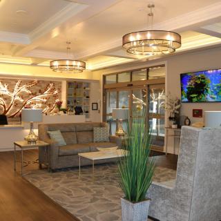 A modern hotel lobby with stylish lighting, comfortable seating, and tasteful decor.