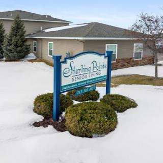 A sign for Sherling Park with a snowy landscape in the foreground.