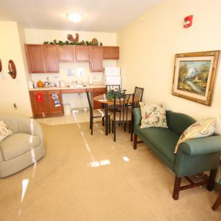 A cozy apartment living space with a kitchen and dining area.