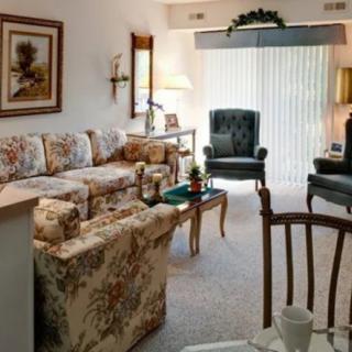 Cozy living room with floral furniture and classic decor.