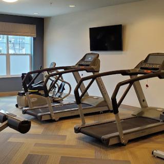 A well-equipped indoor gym featuring treadmills and an elliptical machine.