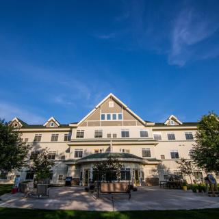 A picturesque hotel with a classic architectural design set against a clear blue sky.