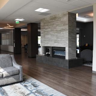 A modern lounge area featuring a stylish fireplace and comfortable seating.