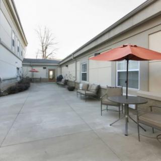 A small courtyard with outdoor seating and an umbrella.