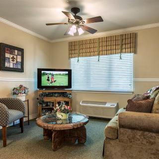 A cozy living room with a television and comfortable seating.