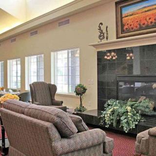 Cozy living room with sofas and a fireplace under a framed artwork.