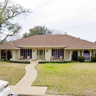 A suburban house with a well-maintained front yard and pathway.