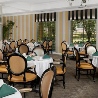 An elegant indoor dining area with neatly arranged tables and chairs, ready for guests.