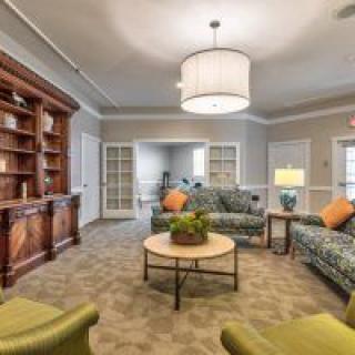 Cozy living room with sofas, bookshelf, and decorative elements.