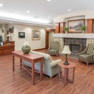 A cozy lobby with a seating area, featuring a fireplace and stylish decor.