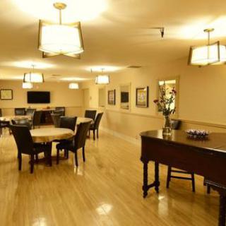 A spacious lounge area featuring elegant furniture and a piano, perfect for gatherings.