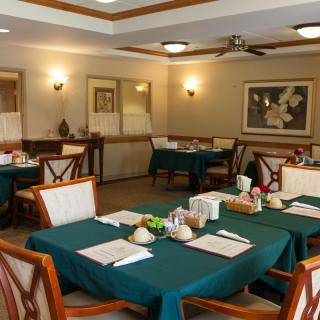 A cozy dining area in a restaurant with neatly set tables and comfortable seating.