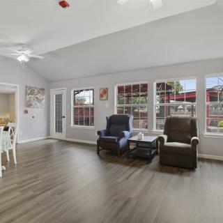 A spacious living room with comfortable seating and large windows.
