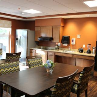 A spacious and modern kitchen and dining area, featuring a well-equipped setup with colorful furniture.