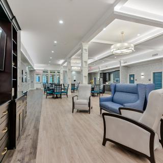 A spacious and modern living room with elegant furniture and lighting.