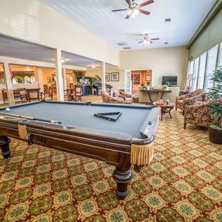 A well-furnished game room featuring a pool table and comfortable seating.
