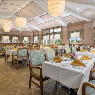 Elegant dining area with neatly arranged tables and decorative lighting.