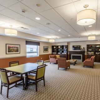 A cozy living area with comfortable seating, a table, and bookshelves.