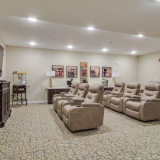 A cozy home theater with plush recliner seats and ambient lighting.
