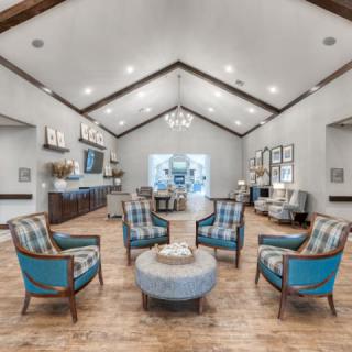 A modern living room with a central seating area and elegant decor.