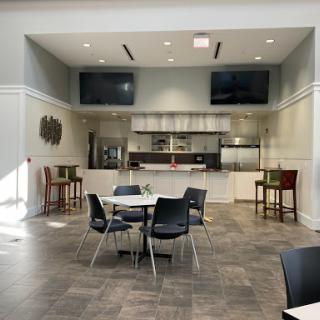 A modern dining area featuring sleek furniture and an open kitchen design.
