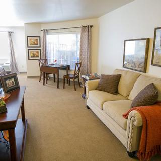 A cozy living room with a sofa, table, and decorative elements.