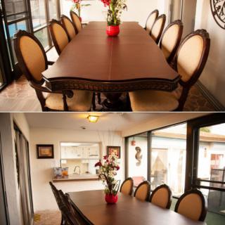 A beautifully set dining table with elegant chairs and a floral centerpiece in a cozy dining room.