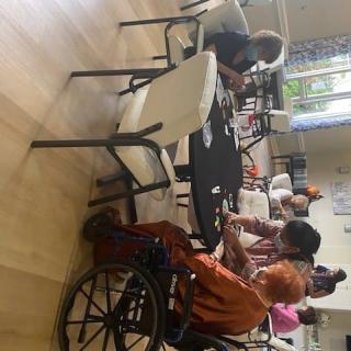 Elderly individuals participating in a group activity in a nursing home.