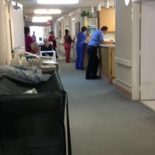 Medical staff working in a hospital hallway.