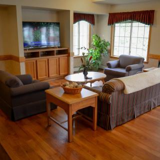 Cozy living room with sofas, a coffee table, and a TV.