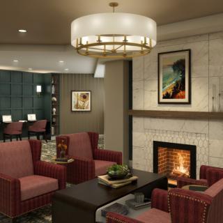 A cozy lounge area with a fireplace, surrounded by comfortable seating and modern decor.
