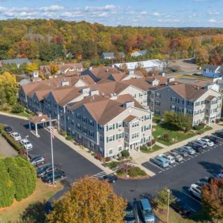 Aerial view of a residential complex surrounded by autumn foliage.