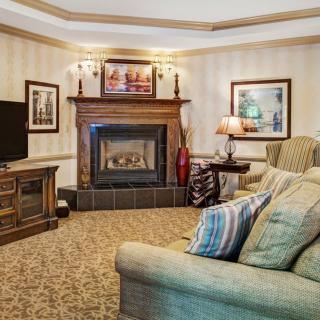 A cozy living room with a warm fireplace and comfortable seating.