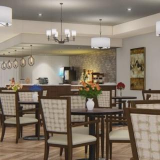 A cozy restaurant interior with elegant lighting and neatly arranged tables and chairs.