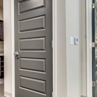 A modern interior door with a sleek design in a well-lit hallway.