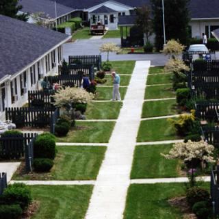 A peaceful residential area featuring well-maintained paths and greenery.