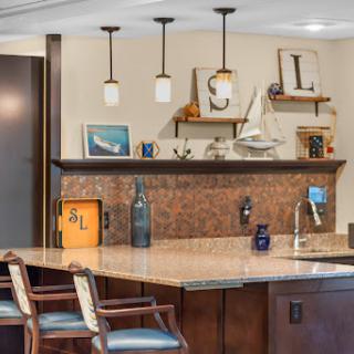 A stylish modern kitchen featuring a bar area with unique lighting and decorative elements.