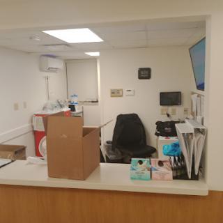 A view of a medical office reception area with equipment and a box.