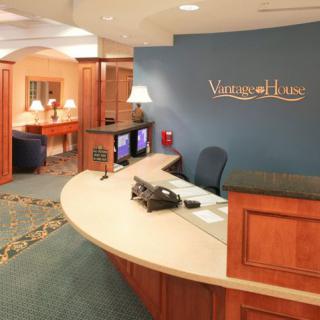 A welcoming hotel lobby with a reception desk and cozy seating area.