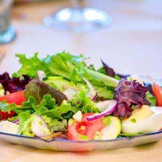A fresh and colorful salad with mixed greens and tomatoes.