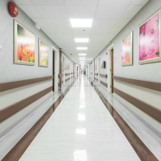 A clean and bright hospital hallway adorned with colorful artwork.