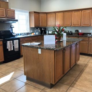 A modern kitchen with wooden cabinets and a central island.