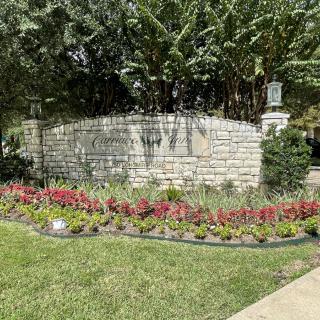 A beautifully landscaped garden featuring vibrant flowers and a stone wall.