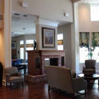 A cozy living room with a fireplace and comfortable seating.