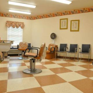 An empty barbershop interior with chairs and salon equipment.