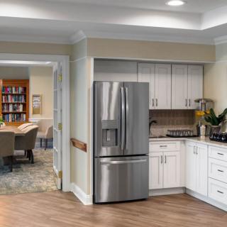 A modern kitchen featuring stainless steel appliances and open space.