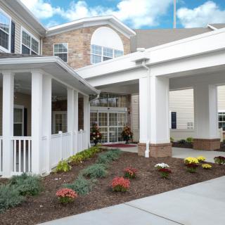 A welcoming building entrance with landscaped surroundings.