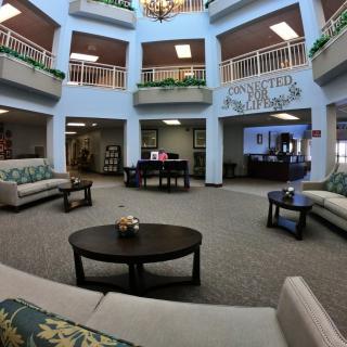 A spacious and well-lit lobby area with comfortable seating arrangements and decorative plants.