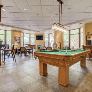 A spacious billiards room with a pool table and seating area.