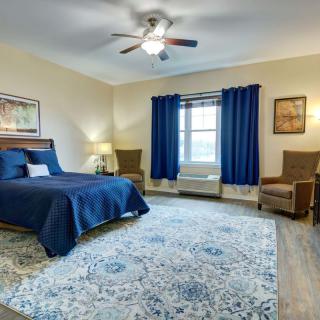 A well-decorated bedroom featuring a blue color scheme with stylish furnishings and a cozy atmosphere.